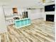 Bright kitchen featuring stainless steel appliances, stylish island, and wood-look flooring at 3936 Murrells Inlet Rd., Murrells Inlet, SC 29576