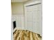 Bright laundry room with wood-look floors, shiplap wainscoting, and white washer and dryer at 3936 Murrells Inlet Rd., Murrells Inlet, SC 29576