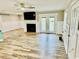 Spacious living room with elegant plank flooring, a cozy fireplace, and an exit to the porch at 3936 Murrells Inlet Rd., Murrells Inlet, SC 29576