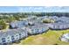Aerial view of multi-Gathering condo building with vibrant landscaping at 4879 Dahlia Ct. # 204, Myrtle Beach, SC 29577