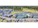 Aerial view of condos, parking, and golf course with pond and trees at 4879 Dahlia Ct. # 204, Myrtle Beach, SC 29577