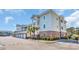 Condo exterior showcasing private garages, ample parking, well maintained landscaping, and accessible parking at 4879 Dahlia Ct. # 204, Myrtle Beach, SC 29577