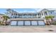 Exterior view of building with garages, balconies, and light green siding at 4879 Dahlia Ct. # 204, Myrtle Beach, SC 29577