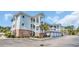 Exterior of the condo building with large balconies, brick accents, and lush landscaping at 4879 Dahlia Ct. # 204, Myrtle Beach, SC 29577