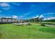 Scenic view of the golf course, pond, and condo buildings at 4879 Dahlia Ct. # 204, Myrtle Beach, SC 29577