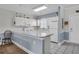 Bright kitchen with white cabinets, neutral counters, and white appliances at 4879 Dahlia Ct. # 204, Myrtle Beach, SC 29577
