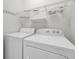 Practical laundry area features a washer and dryer with shelving for storage solutions at 4879 Dahlia Ct. # 204, Myrtle Beach, SC 29577