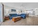 Bright living room with neutral tones featuring blue sofas, wood flooring and an open floorplan at 4879 Dahlia Ct. # 204, Myrtle Beach, SC 29577