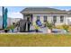 This backyard showcases a well-maintained lawn and a patio equipped with outdoor furniture at 263 Red Maple Loop, Longs, SC 29568