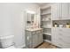 Bathroom featuring a vanity with granite countertop and grey cabinets and a storage shelf and cabinet at 263 Red Maple Loop, Longs, SC 29568