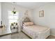 Bright bedroom featuring a padded headboard, a window with a hanging plant and a side table with potted plants at 263 Red Maple Loop, Longs, SC 29568