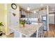 A kitchen with an island featuring granite countertops, stainless steel appliances, gray cabinets and hardwood floors at 263 Red Maple Loop, Longs, SC 29568