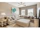 Spacious living room with large sectional sofa, ceiling fan, and ample natural light at 263 Red Maple Loop, Longs, SC 29568