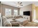 Living room features a cozy sectional sofa, large windows, and ceiling fan at 263 Red Maple Loop, Longs, SC 29568