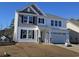 Two-story home with white siding, gray accents, a covered porch, and an attached two-car garage at 5024 Cambria Ct., Little River, SC 29566