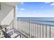Unobstructed balcony view of the sandy beach and ocean beyond with balcony seating at 1205 S Ocean Blvd. # 20702, Myrtle Beach, SC 29577