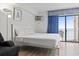 Cozy bedroom offers a queen bed and access to a balcony with ocean views at 1205 S Ocean Blvd. # 20702, Myrtle Beach, SC 29577