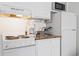 White kitchen with appliances, including a range, microwave, and refrigerator at 1205 S Ocean Blvd. # 20702, Myrtle Beach, SC 29577