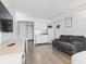 Bright living space features wood floors, sofa, dining table, and a practical, well-equipped kitchen at 1205 S Ocean Blvd. # 20702, Myrtle Beach, SC 29577