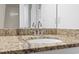 Granite vanity featuring a sink and mirror at 1205 S Ocean Blvd. # 20702, Myrtle Beach, SC 29577