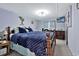 Comfortable bedroom featuring a wooden bed frame, blue bedding and a beach scene on TV at 2511 Ye Olde Kings Hwy., North Myrtle Beach, SC 29582