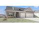 Charming home featuring gray siding, brick accents, and a convenient two-car garage at 299 Hayloft Circle, Conway, SC 29526