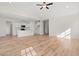 Open-concept living room with wood flooring, a ceiling fan, and a view of the kitchen at 299 Hayloft Circle, Conway, SC 29526