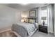 Cozy bedroom with gray bedding, nightstands, and window curtains at 704 St. Albans Loop, Conway, SC 29526