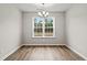 Bright dining room with hardwood floors and a large window at 902 Owls Nest Dr., Conway, SC 29527