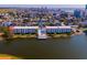 Aerial view of condo community on a lake with pool, surrounded by scenic views and close to the beach at 1919 Spring St. # B-16, North Myrtle Beach, SC 29582