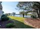 Lush backyard landscaping with view of tranquil lake at 1919 Spring St. # B-16, North Myrtle Beach, SC 29582