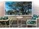 Inviting balcony seating overlooks a serene lake and lush landscaping at 1919 Spring St. # B-16, North Myrtle Beach, SC 29582