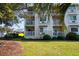 View of the condo's lovely outdoor balcony on a lush green lawn with mature trees at 1919 Spring St. # B-16, North Myrtle Beach, SC 29582