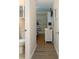 Hallway view into bedroom featuring white dresser, hardwood floors, and ensuite bathroom at 1919 Spring St. # B-16, North Myrtle Beach, SC 29582