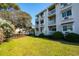 Multi-level condominium featuring private balconies and manicured lawn at 1919 Spring St. # B-16, North Myrtle Beach, SC 29582