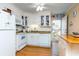 Well-lit kitchen with white appliances, subway tile backsplash, and wood-look flooring at 1919 Spring St. # B-16, North Myrtle Beach, SC 29582