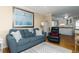 View of the living room, featuring a cozy blue sofa with throw pillows at 1919 Spring St. # B-16, North Myrtle Beach, SC 29582