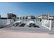 Waterfront outdoor gathering area with picnic tables, lounge chairs and white railing offering picturesque community views at 1919 Spring St. # B-16, North Myrtle Beach, SC 29582