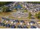 An aerial view shows a planned community featuring a pond, clubhouse, and well-maintained homes at 2169 Wedgewood Dr., Longs, SC 29568