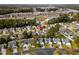An aerial view shows a residential neighborhood with mature trees and proximity to retail and commercial areas at 2169 Wedgewood Dr., Longs, SC 29568