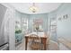 Bright dining room features wood table, six windows, and stainless steel refrigerator and updated light fixture at 2169 Wedgewood Dr., Longs, SC 29568