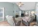 Bright living room with vaulted ceilings, wood floor, and two comfortable gray couches and fireplace at 2169 Wedgewood Dr., Longs, SC 29568