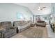 Bright living room with vaulted ceilings, wood floor, and three comfortable gray couches and fireplace at 2169 Wedgewood Dr., Longs, SC 29568