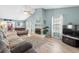 Bright living room with vaulted ceilings, wood floor, and two comfortable gray couches and fireplace at 2169 Wedgewood Dr., Longs, SC 29568
