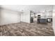 Open concept kitchen and dining area with grey island, stainless steel appliances, and wood-look floors at 218 Eva Dr., Loris, SC 29569
