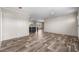 Open living area with wood-look floors and kitchen view at 218 Eva Dr., Loris, SC 29569