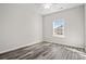 Well-lit bedroom featuring wood-look floors and a large window at 307 Hayloft Circle, Conway, SC 29526