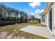 View of a backyard featuring a concrete patio, canal and well-maintained landscaping with mature trees and lush green grass at 4659 East Walkerton Rd., Myrtle Beach, SC 29579