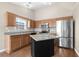 Bright kitchen with wood cabinets, granite countertops, stainless steel appliances, and a center island at 4659 East Walkerton Rd., Myrtle Beach, SC 29579