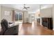 Cozy living space with a fireplace, hardwood floors, and slider to patio with wooded view at 4659 East Walkerton Rd., Myrtle Beach, SC 29579